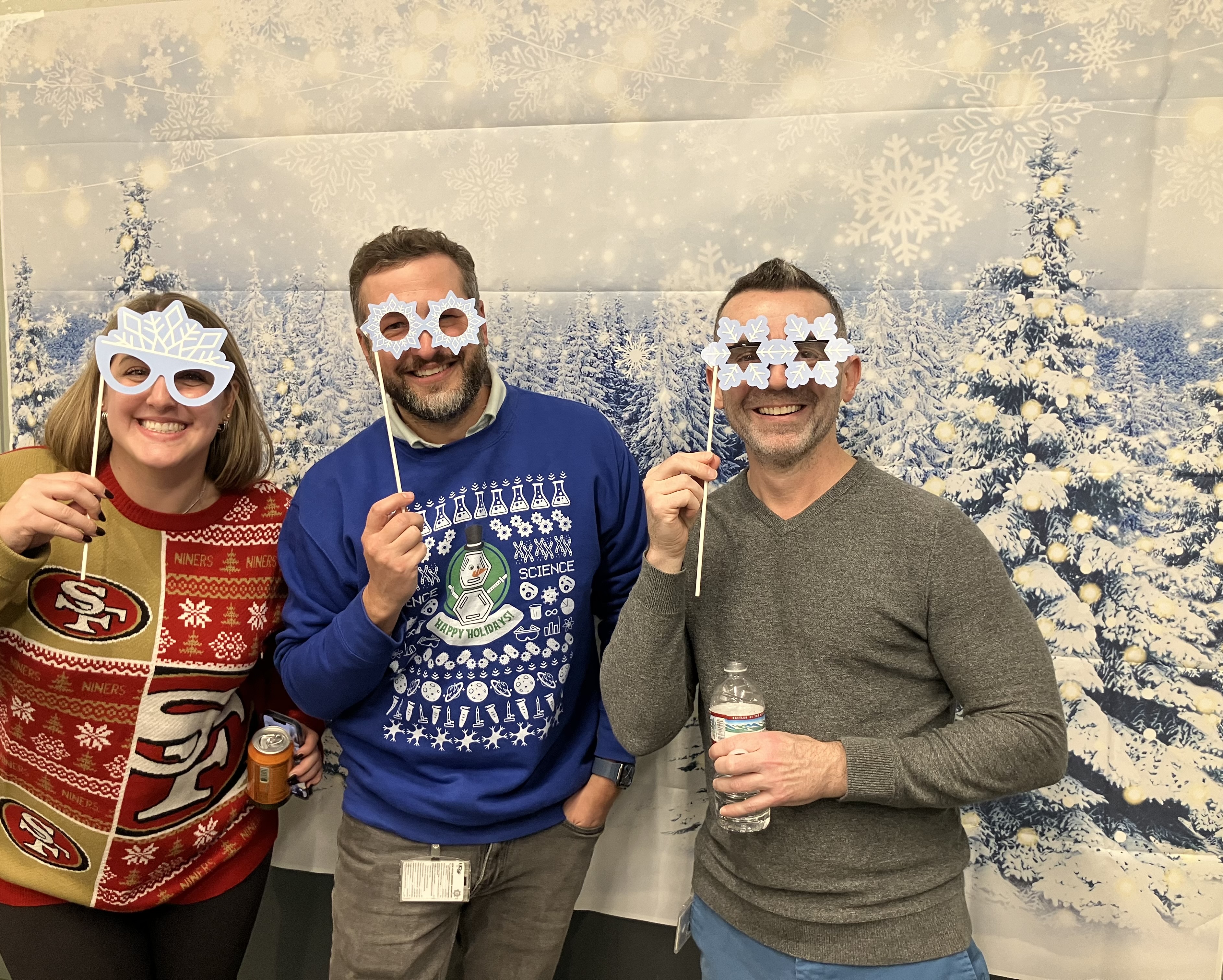 IND members with snowflake glasses and holiday sweaters